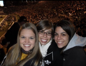 three college aged women posing for a photo at a Mizzou football game